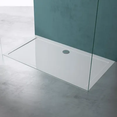 A modern shower tray with a glass enclosure in a bathroom setting.
