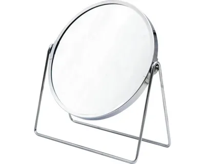 A silver, round cosmetic mirror on a stand.