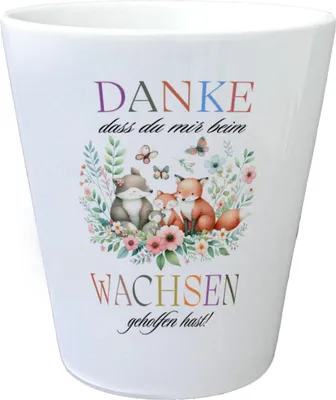 A white ceramic pot with a colorful illustration of foxes and flowers, and German text.