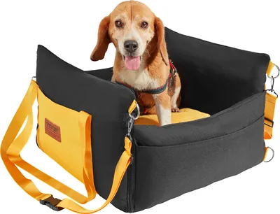 A dog sits in a car seat designed for pets.