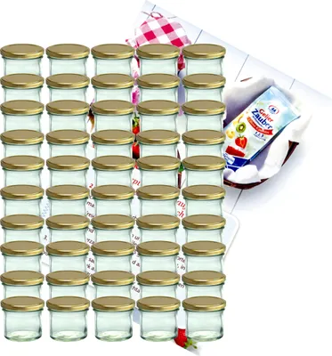 A set of glass jars with gold lids, arranged in rows, with a small recipe booklet in the background.