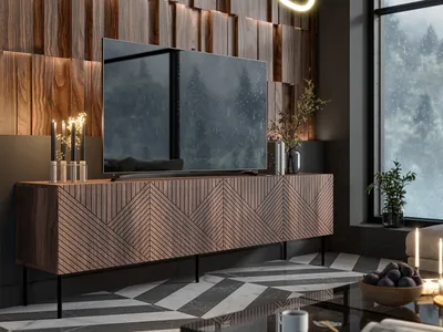 A modern living room with a TV stand, TV, and decorative elements.