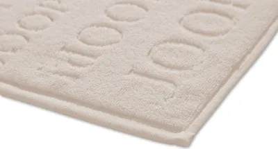 A close-up view of a textured bath mat with an embossed pattern.