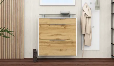 A shoe cabinet with two drawers and a shelf, placed in a hallway with a coat rack and a plant.