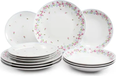 A collection of white ceramic plates and bowls with a floral pattern.
