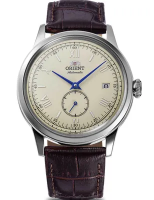 A close-up studio shot of a men's wristwatch with a brown leather strap.