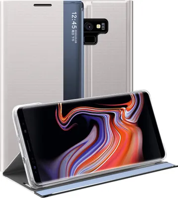 A silver flip case for a Samsung Galaxy Note 9 is shown, with the phone inside and the screen displaying a colorful abstract image. The case is open, revealing the phone and its camera.