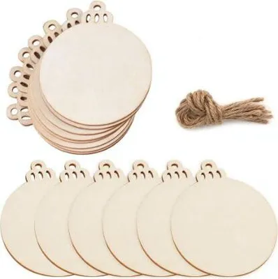 A stack of round wooden ornaments with decorative edges and a bundle of twine on a white background.