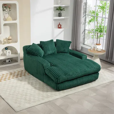 A green corduroy sofa is shown in a living room setting.