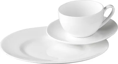 A white ceramic cup and saucer are placed on a larger white plate.