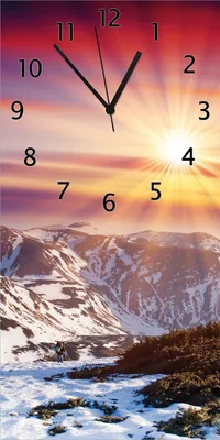 Produktbild von Wallario Design Wanduhr bedruckt, Größe 30 x 60 cm, Motiv: Farbenfroher Sonnenuntergang im Winter - Schnee in den Bergen