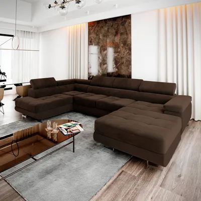 A modern living room with a large sectional sofa, coffee table, and abstract art on the wall.