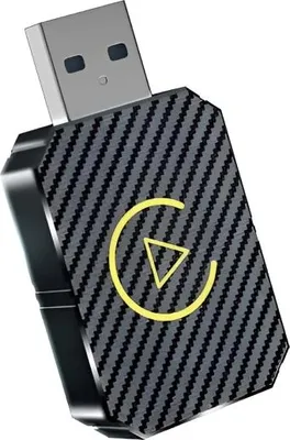 A close-up studio shot of a USB car adapter with a carbon fiber texture and a yellow circular logo with a triangle inside.