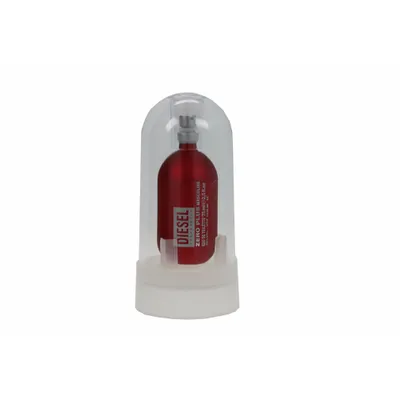 A red bottle of Diesel Zero Plus Eau De Toilette is displayed inside a clear plastic dome on a white base.