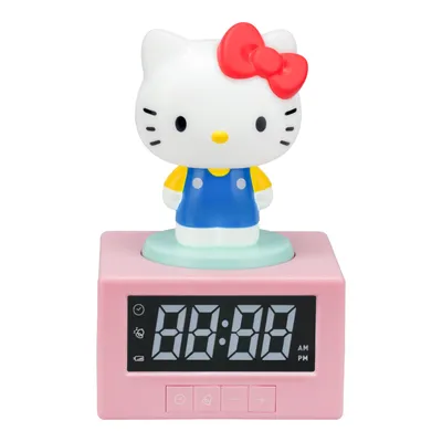 A pink digital alarm clock with a Hello Kitty figure on top.