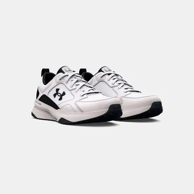 A pair of white and black Under Armour sports shoes are shown against a white background.