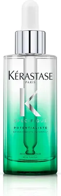 A bottle of Kérastase hair serum with a dropper.