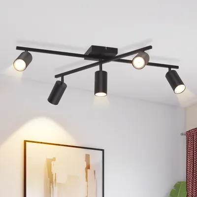 A black ceiling spotlight fixture with five adjustable heads is mounted on a white ceiling.