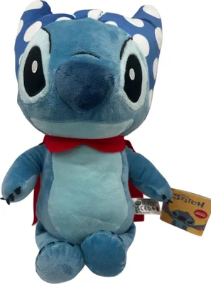 A plush toy of the character Stitch from Disney's Lilo & Stitch, wearing a red cape and a blue and white polka dot headpiece.