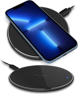 Two black wireless charging pads are shown, one with a smartphone on it.