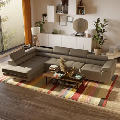 A modern living room with a large sectional sofa, coffee table, and decorative items.