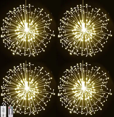 Four glowing dandelion-shaped light decorations against a black background.