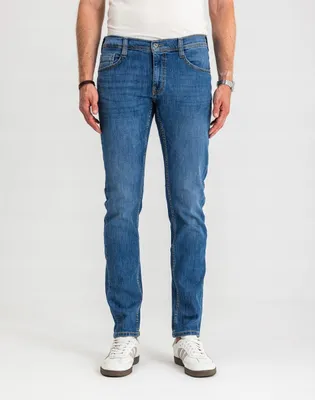 A person is standing and modeling jeans.