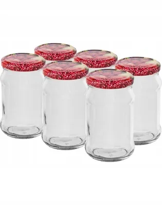 A group of six empty glass jars with red lids.