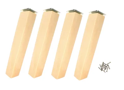 Four wooden furniture legs with metal mounting plates and a pile of screws on a white background.