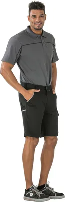 A man wearing a gray polo shirt and black shorts, standing against a white background.