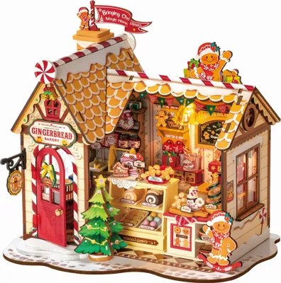 A 3D wooden puzzle model of a gingerbread bakery decorated for Christmas.