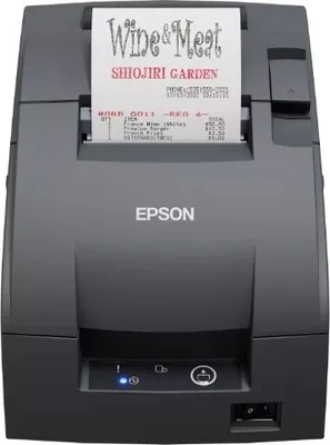A dark gray Epson receipt printer with a printed receipt showing a restaurant name and order details.