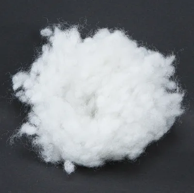 A pile of white fluffy material on a black background.