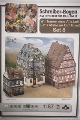 A product image showing a cardboard model kit of old town buildings.
