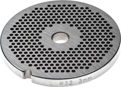 A close-up, top-down view of a metal grinder plate with many small holes.