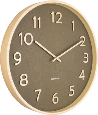 A Karlsson wall clock with a wooden frame and a moss green face.
