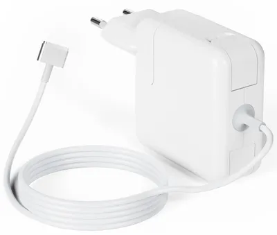 A white Apple Macbook charger with its cable coiled next to it, on a white background.