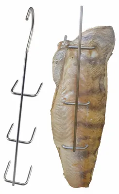A metal rack with hooks for smoking meat or fish, shown next to a piece of smoked fish.