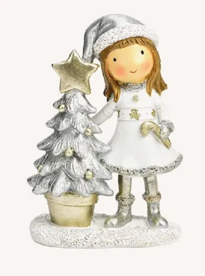 Junges Mädchen das festlich gekleidet ist und neben geschmückten Weihnachtsbaum steht.