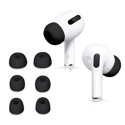 A product shot of white earbuds with black ear tips and a set of black ear tips arranged to the left.