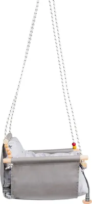 A baby swing chair hanging from ropes.