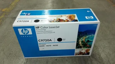 A product box for an HP Color LaserJet toner cartridge is shown on a concrete floor.