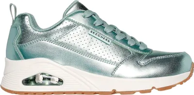 A side view of a green Skechers sneaker.