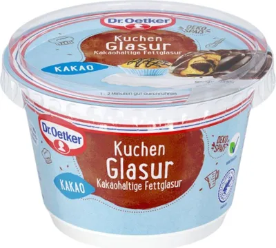 A close-up of a plastic tub of Dr. Oetker Kuchen Glasur (cake glaze) with Kakao (cocoa) flavor.