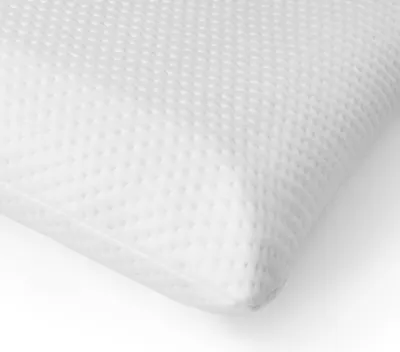 A close-up view of a white pillow with a textured surface.