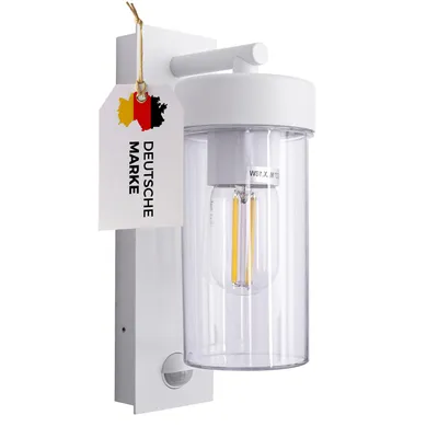 A white outdoor wall light with a clear glass cylinder and a motion sensor.