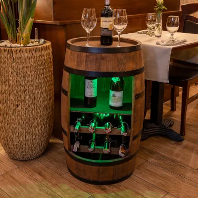A wine barrel-shaped cabinet with shelves for bottles and glasses is displayed indoors.