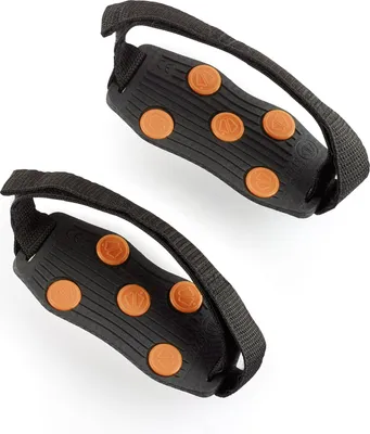 A pair of black traction devices with orange studs and black straps, shown against a white background.
