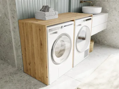 A modern bathroom with a washing machine and dryer cabinet.