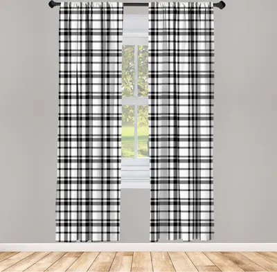 Two plaid curtains hanging in front of a window.